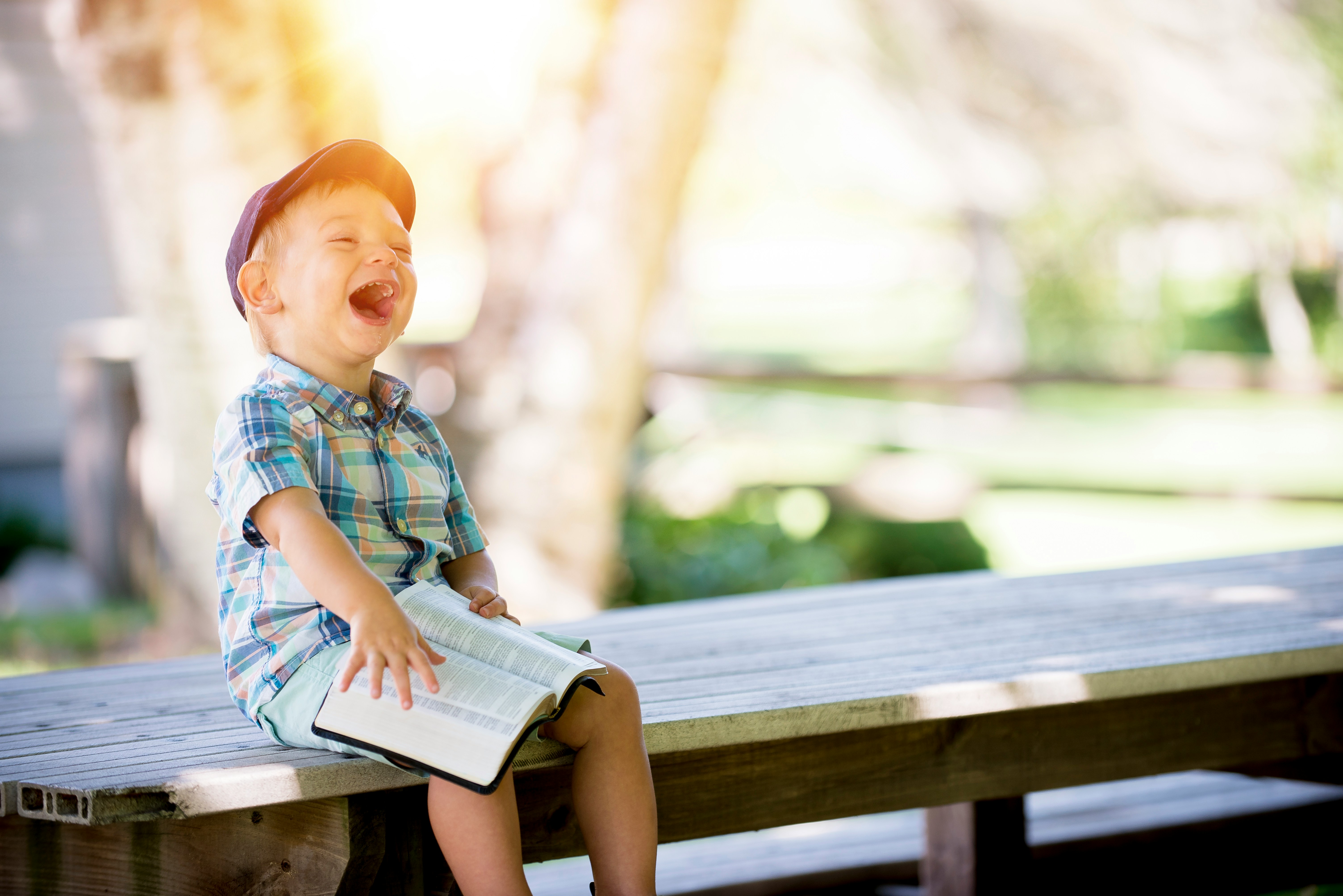 A boy reading a bible with joy.