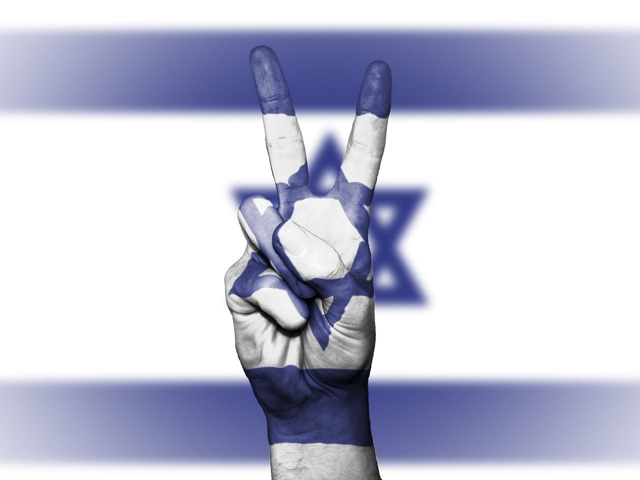 Israel flag with a hand sign of peace on it in the foreground of the flag that nearly transparent